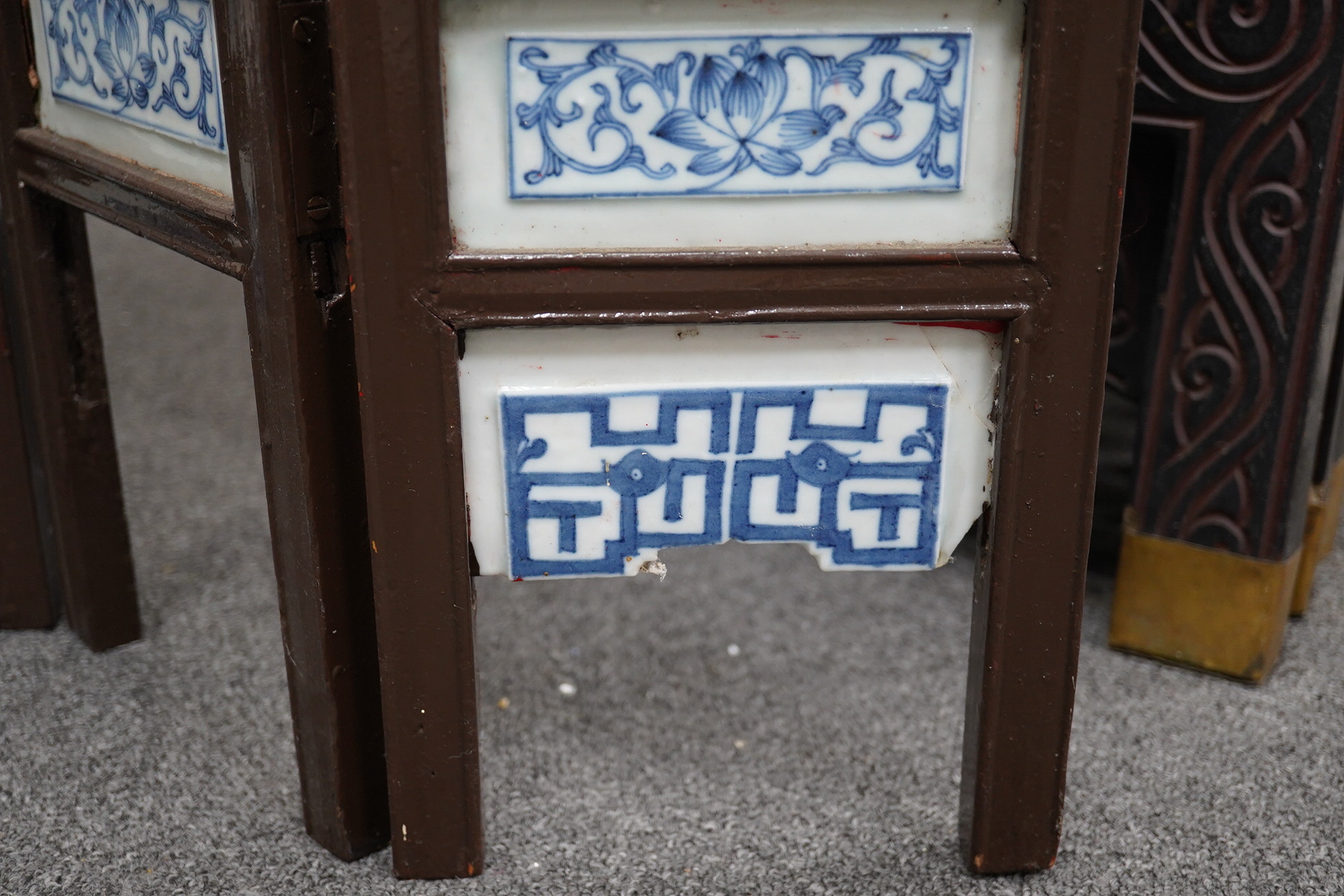 A Chinese wood framed and porcelain mounted low screen, late 19th century